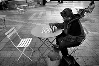 Malachi waits at Westlake Plaza in Seattle for anyone who wants to play chess, to have a seat. A couple minutes after this, a young guy sat down to play.