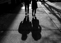 A couple walk the streets of Seattle as the sun sets on the empty city.